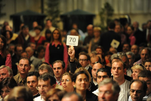 Luxury watch auction hall during record-breaking bidding for the most expensive watches ever sold